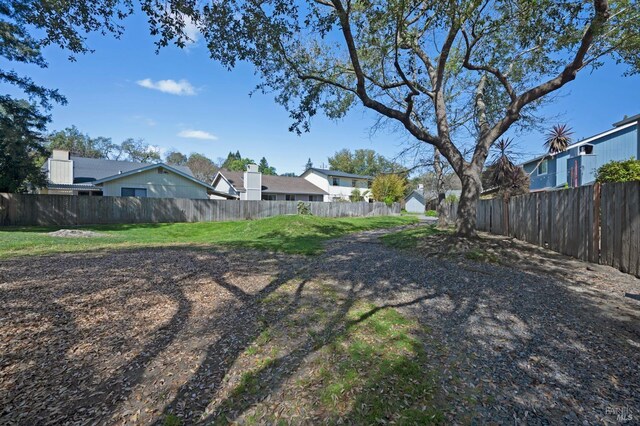 view of yard with a residential view and a fenced backyard