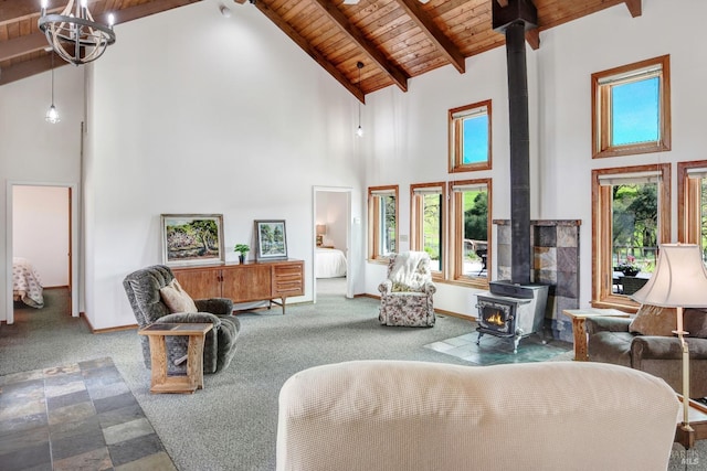11747 Creek Hollow Rd, Healdsburg, CA 95448 - living room featuring a wood stove, high vaulted ceiling, wooden ceiling with exposed beams, carpet, and baseboards