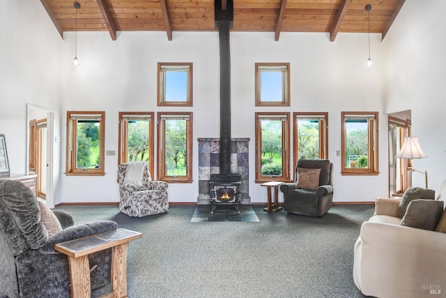 11747 Creek Hollow Rd, Healdsburg, CA 95448 - carpeted living area featuring a wood stove, wooden ceiling with exposed beams, high vaulted ceiling, plenty of natural light, and baseboards