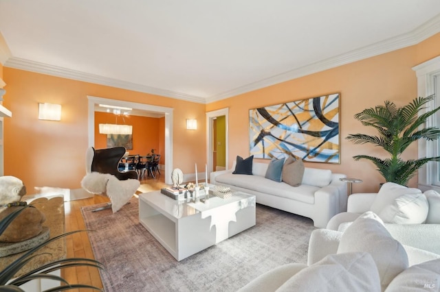 living area with ornamental molding and light wood-style floors