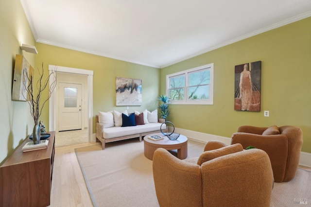 living area with ornamental molding and wood finished floors