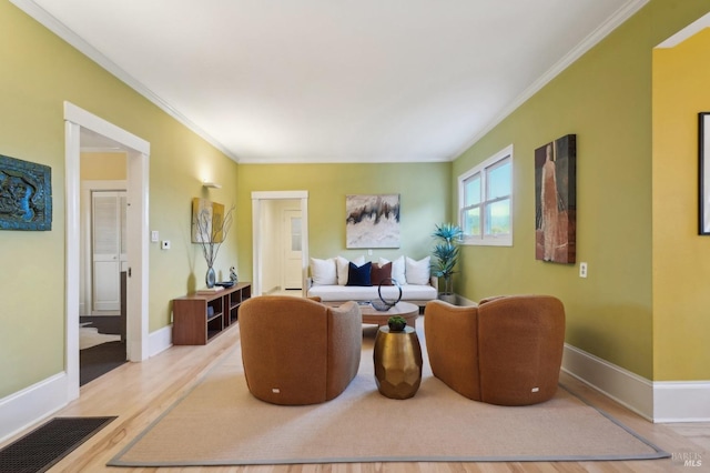 living area with ornamental molding, baseboards, visible vents, and wood finished floors