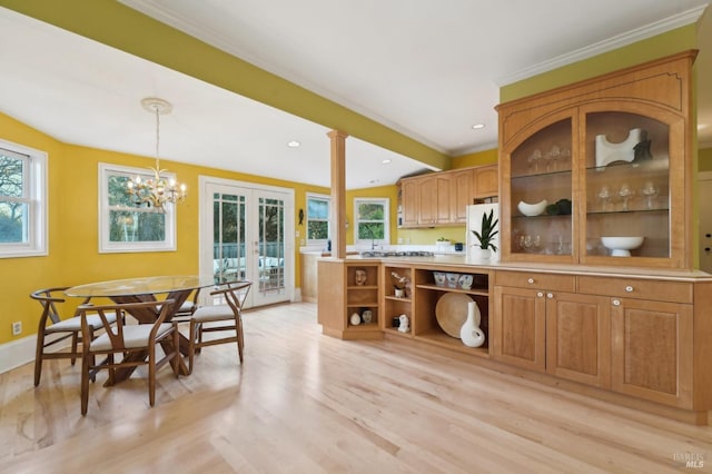 kitchen featuring freestanding refrigerator, french doors, light wood-style flooring, and a healthy amount of sunlight