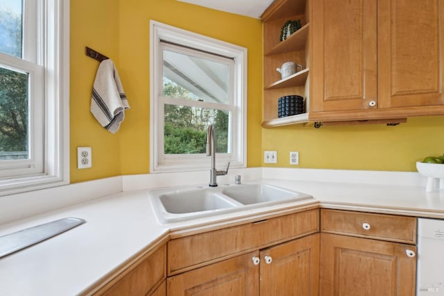 kitchen with open shelves, light countertops, dishwasher, and a sink