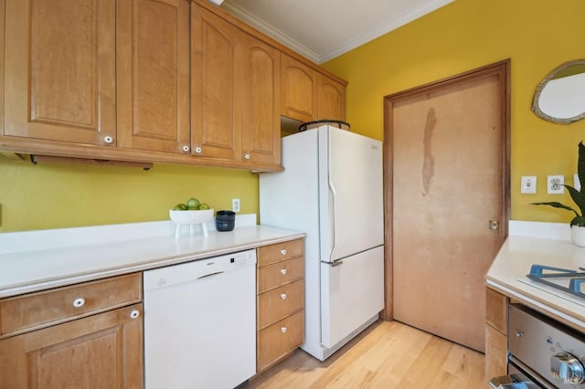 kitchen featuring light countertops, light wood-style floors, crown molding, and white appliances
