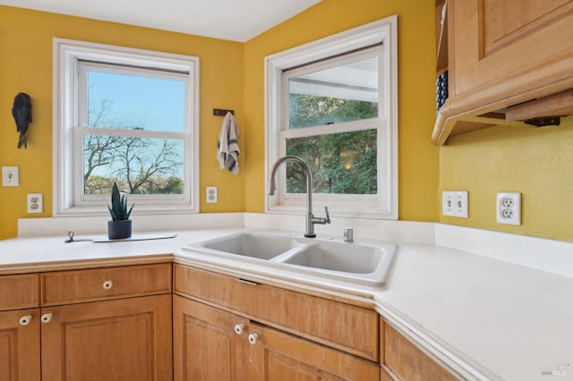 kitchen featuring a sink, brown cabinetry, and light countertops