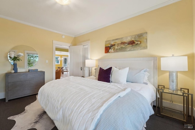 bedroom with crown molding and carpet flooring
