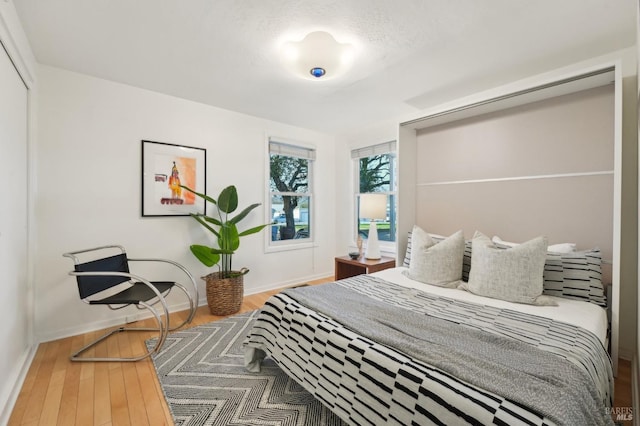 bedroom featuring baseboards and wood finished floors