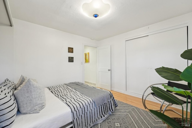 bedroom featuring a closet and wood finished floors