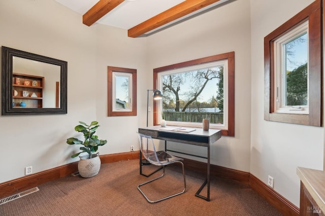 carpeted home office with baseboards, visible vents, and beam ceiling