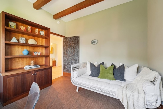 living area featuring dark carpet and beam ceiling