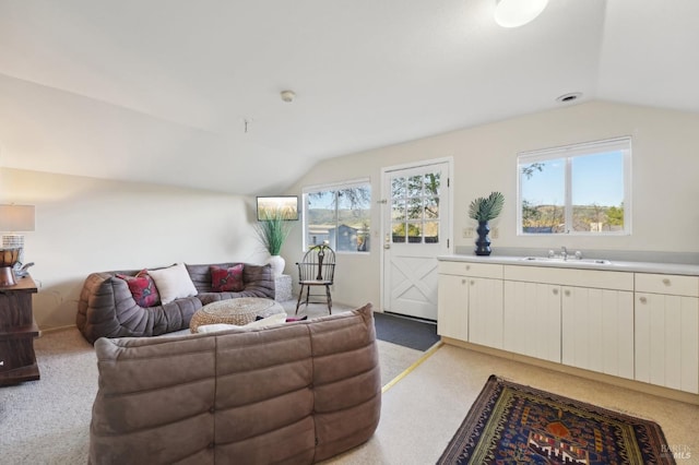 interior space with vaulted ceiling and light carpet
