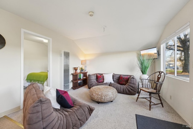 carpeted living room with a heating unit and lofted ceiling