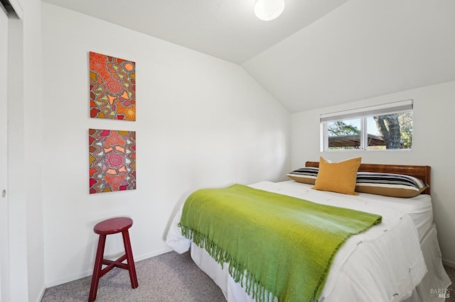bedroom featuring lofted ceiling, carpet flooring, and baseboards