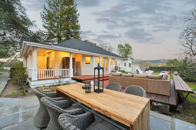 back of house with outdoor dining area and an outdoor living space