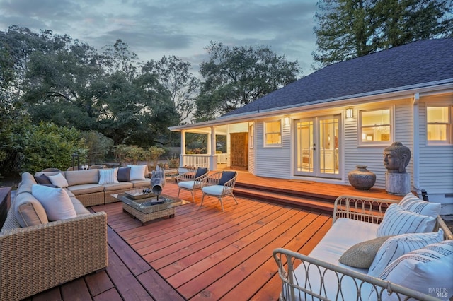 wooden terrace featuring an outdoor hangout area and french doors