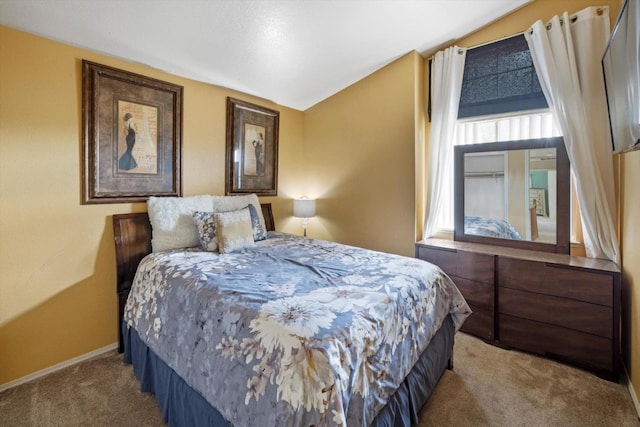 carpeted bedroom featuring baseboards