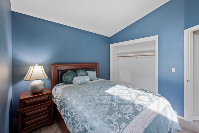 carpeted bedroom featuring vaulted ceiling, baseboards, and a closet