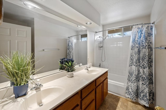 full bathroom featuring double vanity, tile patterned flooring, shower / bath combo, and a sink