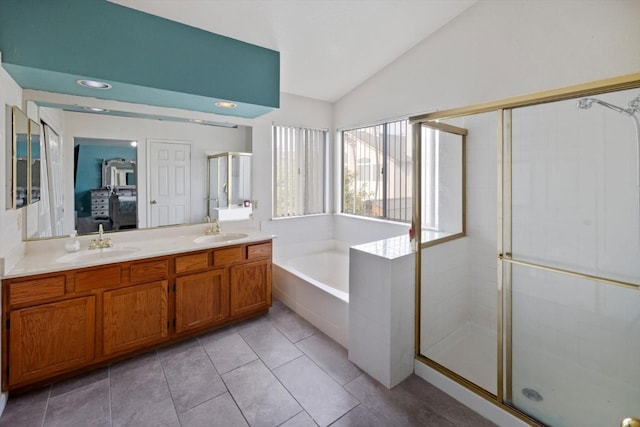 ensuite bathroom featuring a sink, a shower stall, ensuite bathroom, and vaulted ceiling