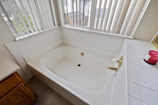 full bathroom featuring a wealth of natural light and a bath