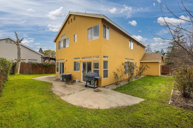 rear view of house featuring central AC unit, a fenced backyard, stucco siding, a patio area, and a lawn