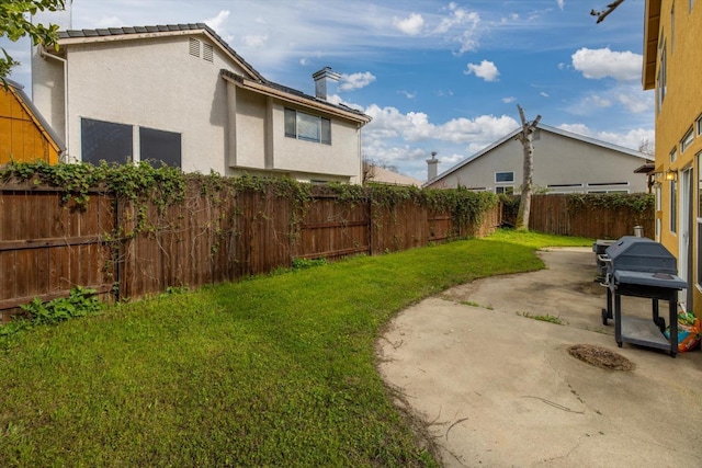 view of yard with a fenced backyard and a patio