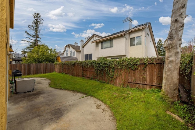 view of yard with a patio and a fenced backyard