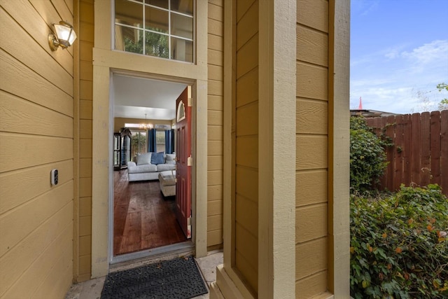 doorway to property featuring fence