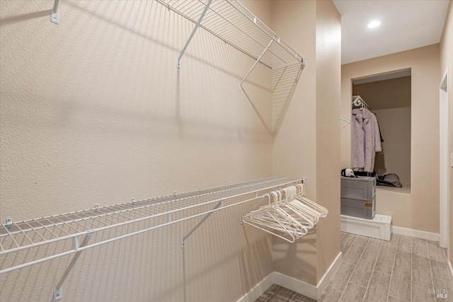 spacious closet with wood finish floors