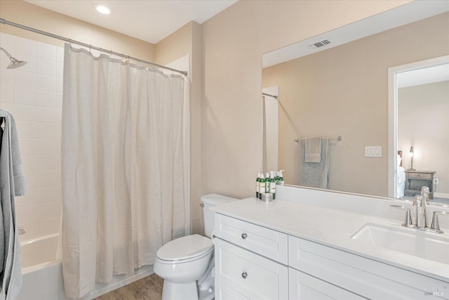 full bath with toilet, vanity, shower / bath combo, wood finished floors, and visible vents