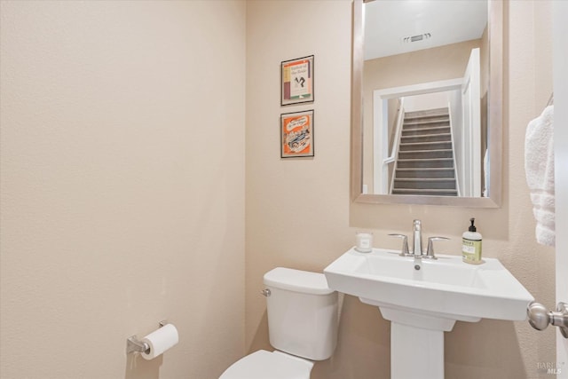 half bath with toilet and visible vents