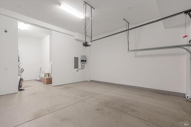 garage with a garage door opener and electric panel