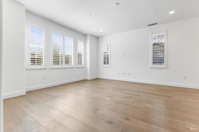 spare room featuring recessed lighting, visible vents, baseboards, and light wood finished floors
