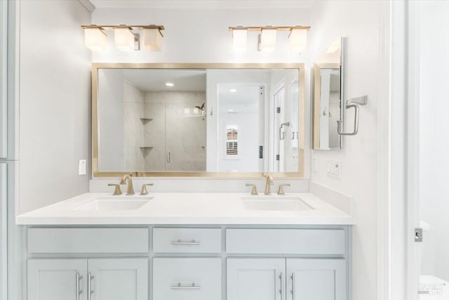 full bathroom with a sink, double vanity, and a shower stall