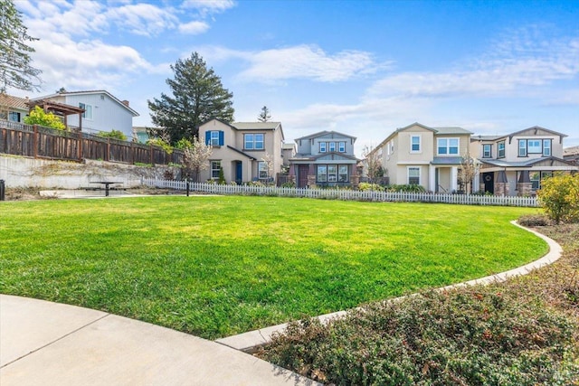 view of yard with fence and a residential view