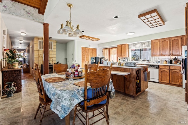 dining room with a chandelier and ornate columns