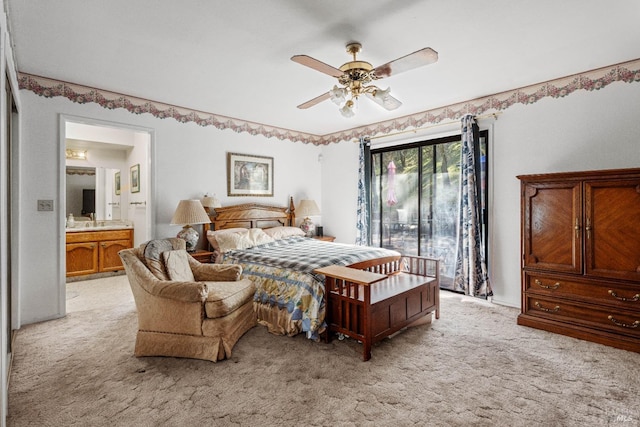 bedroom with a sink, connected bathroom, light colored carpet, and a ceiling fan