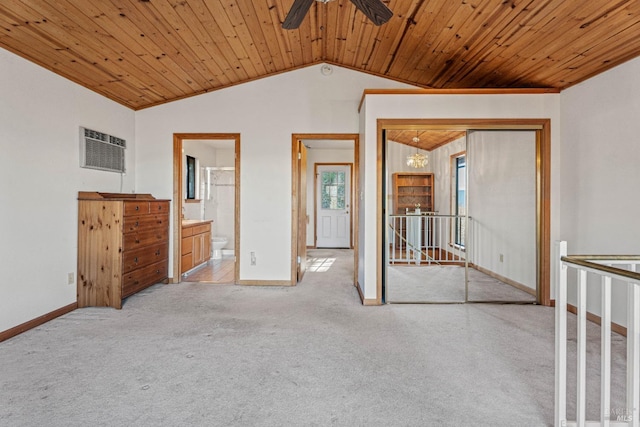 unfurnished bedroom featuring baseboards, lofted ceiling, wood ceiling, a closet, and carpet flooring