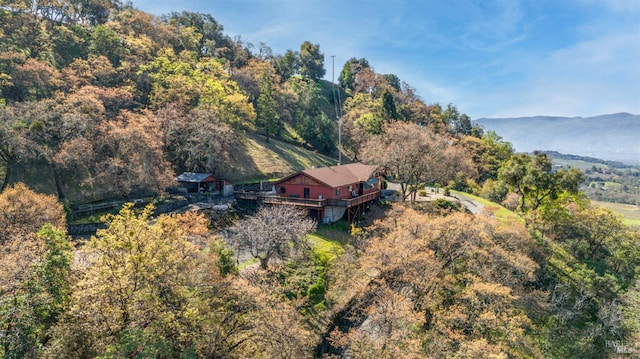 birds eye view of property with a mountain view and a wooded view