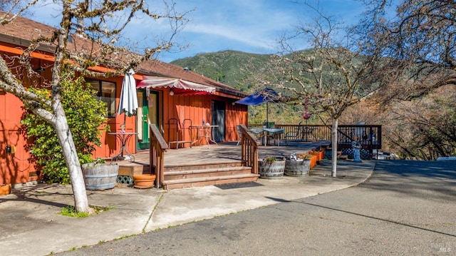 exterior space featuring a deck with mountain view