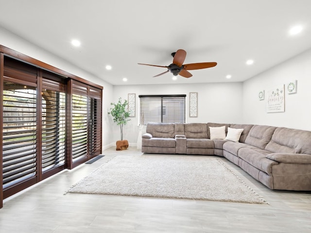 living room featuring recessed lighting, baseboards, and ceiling fan