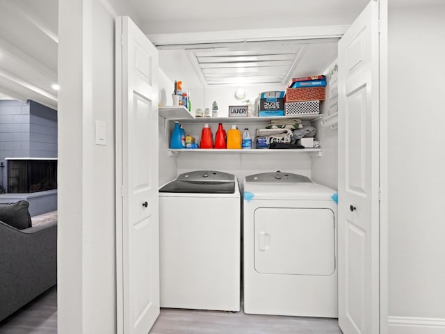 laundry room with laundry area, light wood-style flooring, and independent washer and dryer