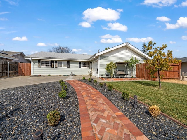 ranch-style home featuring driveway, a front yard, and fence