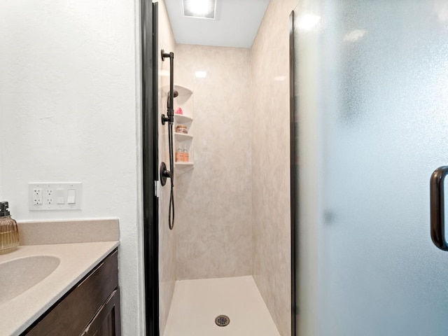 full bathroom with a shower stall and vanity