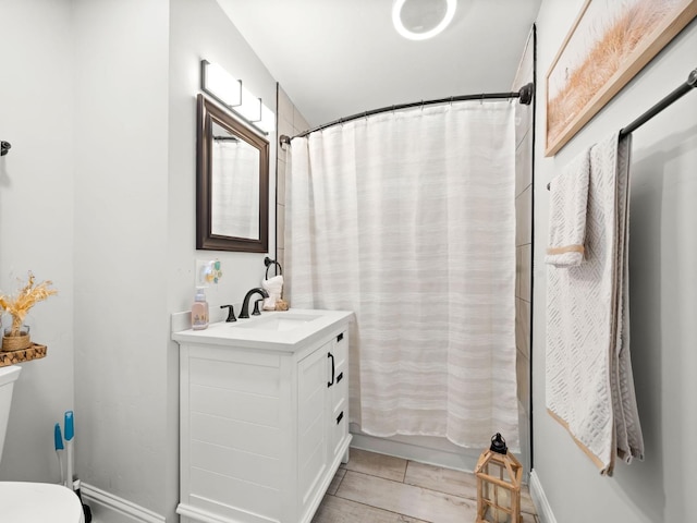 full bathroom featuring vanity and toilet