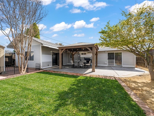 back of house featuring a gazebo, a patio area, a lawn, and fence