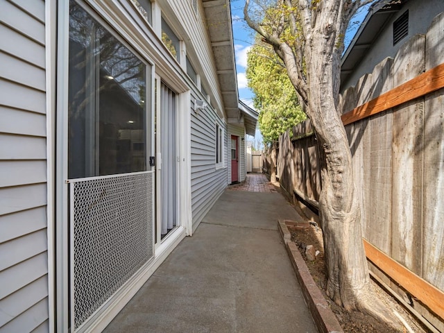 view of side of property with a patio and fence