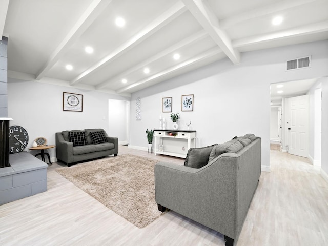 living room with visible vents, light wood-style flooring, recessed lighting, baseboards, and vaulted ceiling with beams