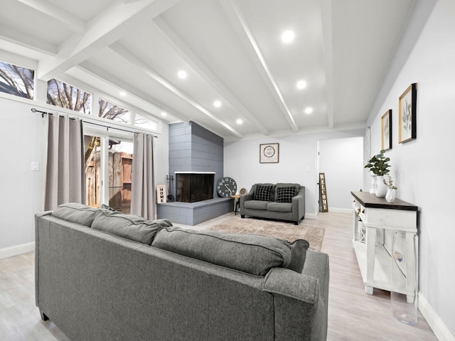 living room with recessed lighting, a fireplace, light wood finished floors, baseboards, and vaulted ceiling with beams